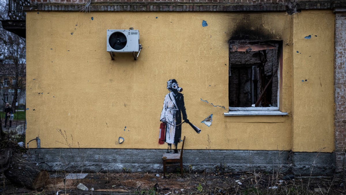 A graffiti image of woman in a gas mask and a bathrobe.
