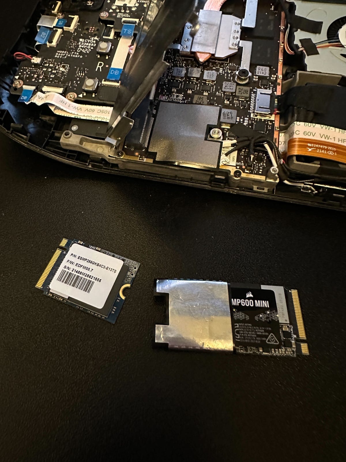 an opened steam deck and two SSDs on a table