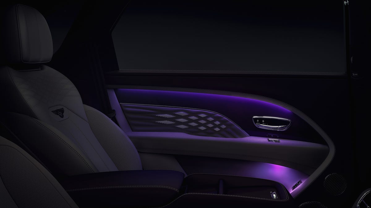 dark teaser image of a door in a new Bentley, lit in purple