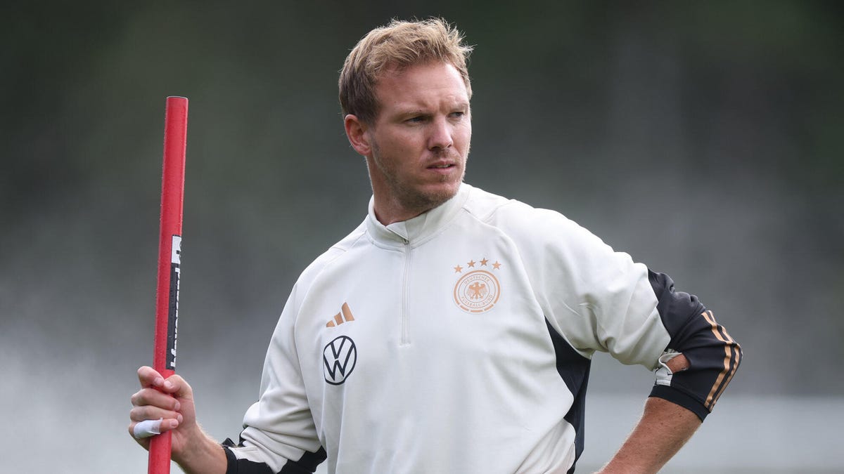 Julian Nagelsmann, head coach of Germany, holding a pole while looking to his left during a training session