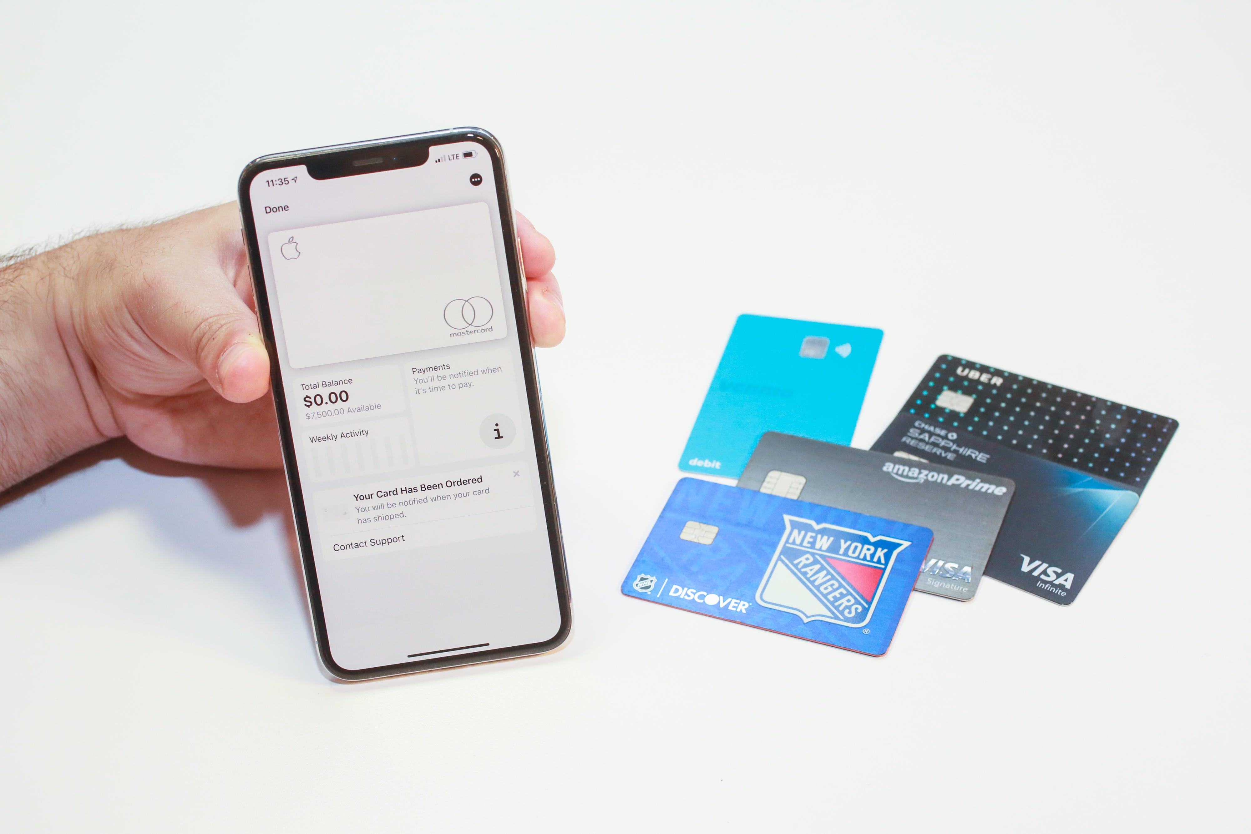 apple credit card on iPhone and four physical credit cards