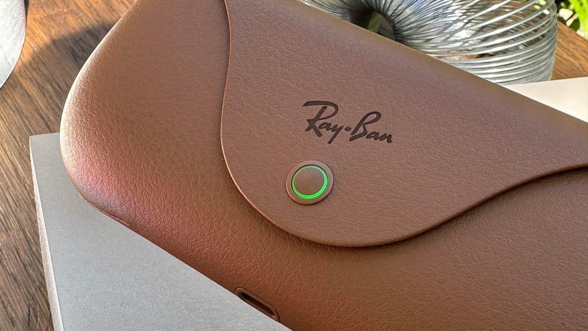 A leather Ray-Ban charging case for glasses, with a button glowing green