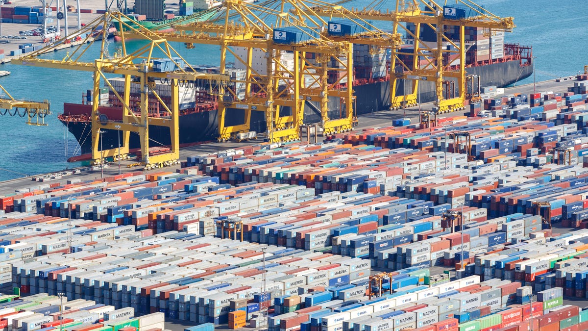 A colossal amount of cargo goes through the world's ports, like Barcelona's here in Spain, sent by standard-sized containers loaded on and off ships, trucks and trains. IBM and allies say their TradeLens blockchain-based network streamlines the paperwork.