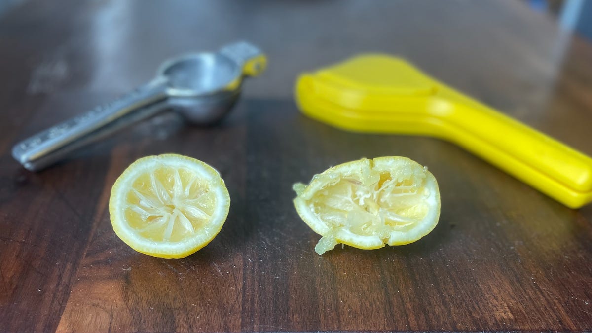 fluicer and traditional juicer with squeezed lemons