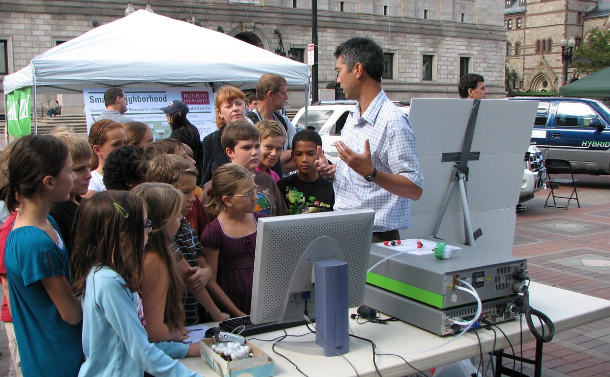Boston University professor Nathan Phillips (on right, speaking) spoke to students from a local school in Copley Square Boston about monitoring carbon dioxide and the exchange of CO2 between trees and emitters, such as vehicles.