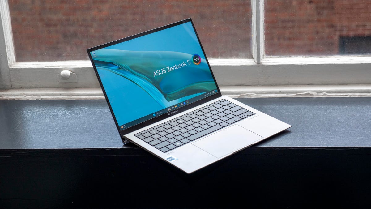 Asus Zenbook S 13 OLED 13-inch laptop open on a window sill.