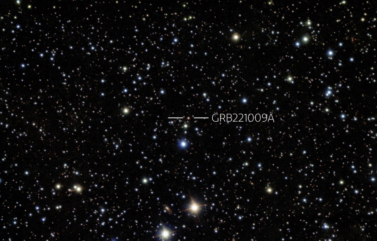 In the center of the image, among a vast array of stars against the black background of space, lies a highlighted speck. This is where the burst came from.