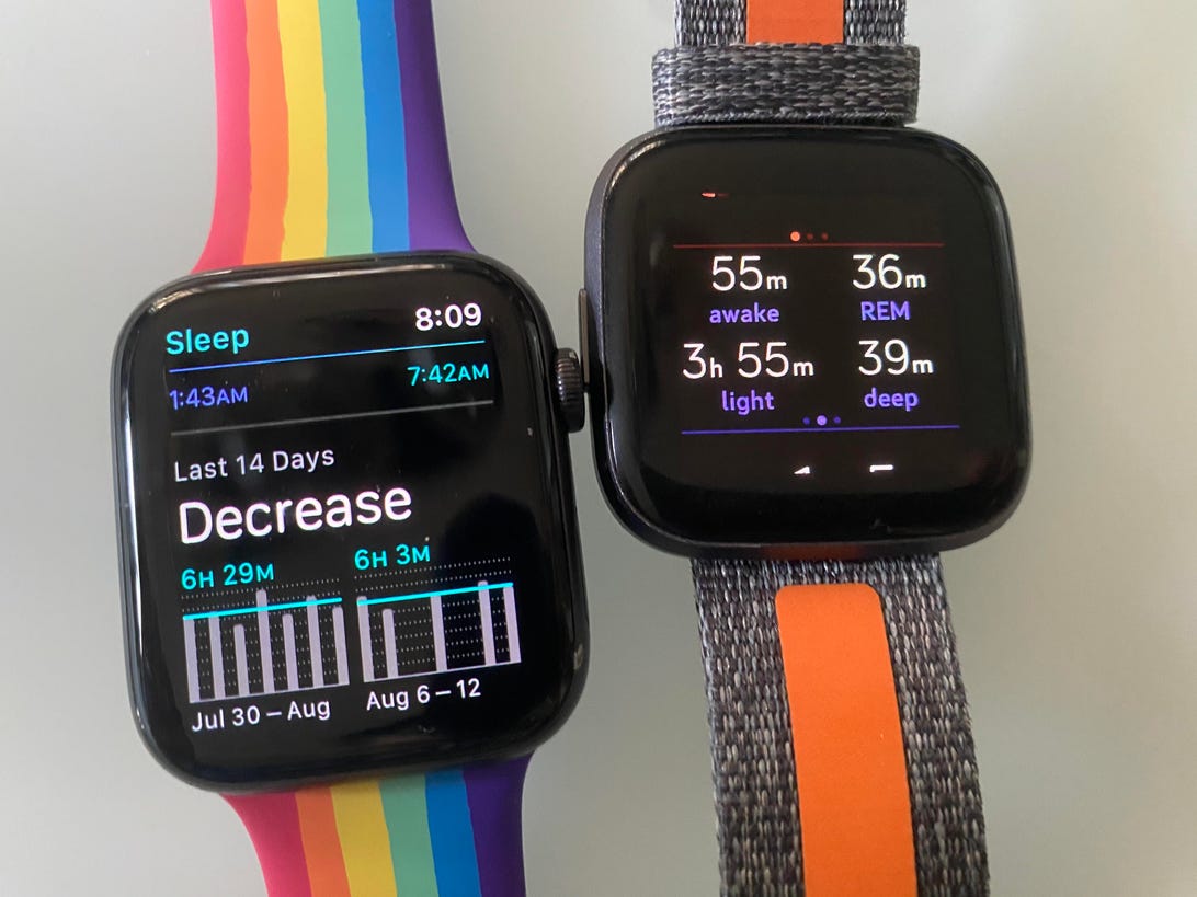 Apple Watch next to Fitbit Versa