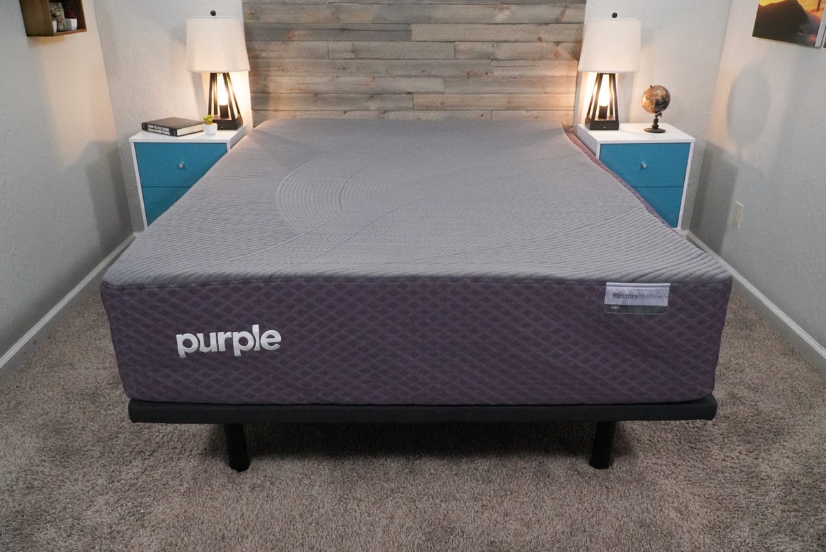 The Purple Restore Premier mattress in between two night stands