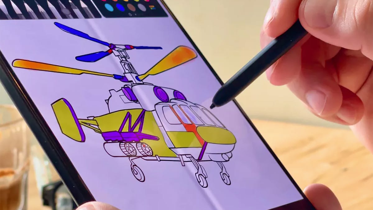 Samsung Galaxy Z Fold 3 with a drawing being shown on its screen and a hand holding the S Pen