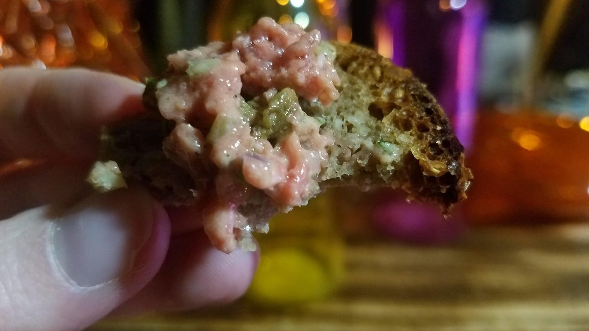 A closeup of fake beef tartare on slice of bread