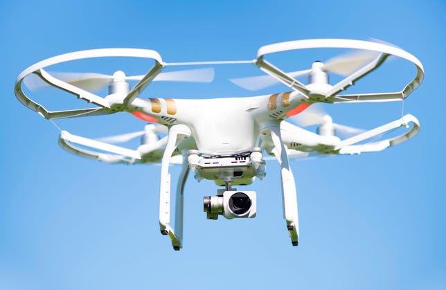 White drone flying high in the air, these unmanned aerial