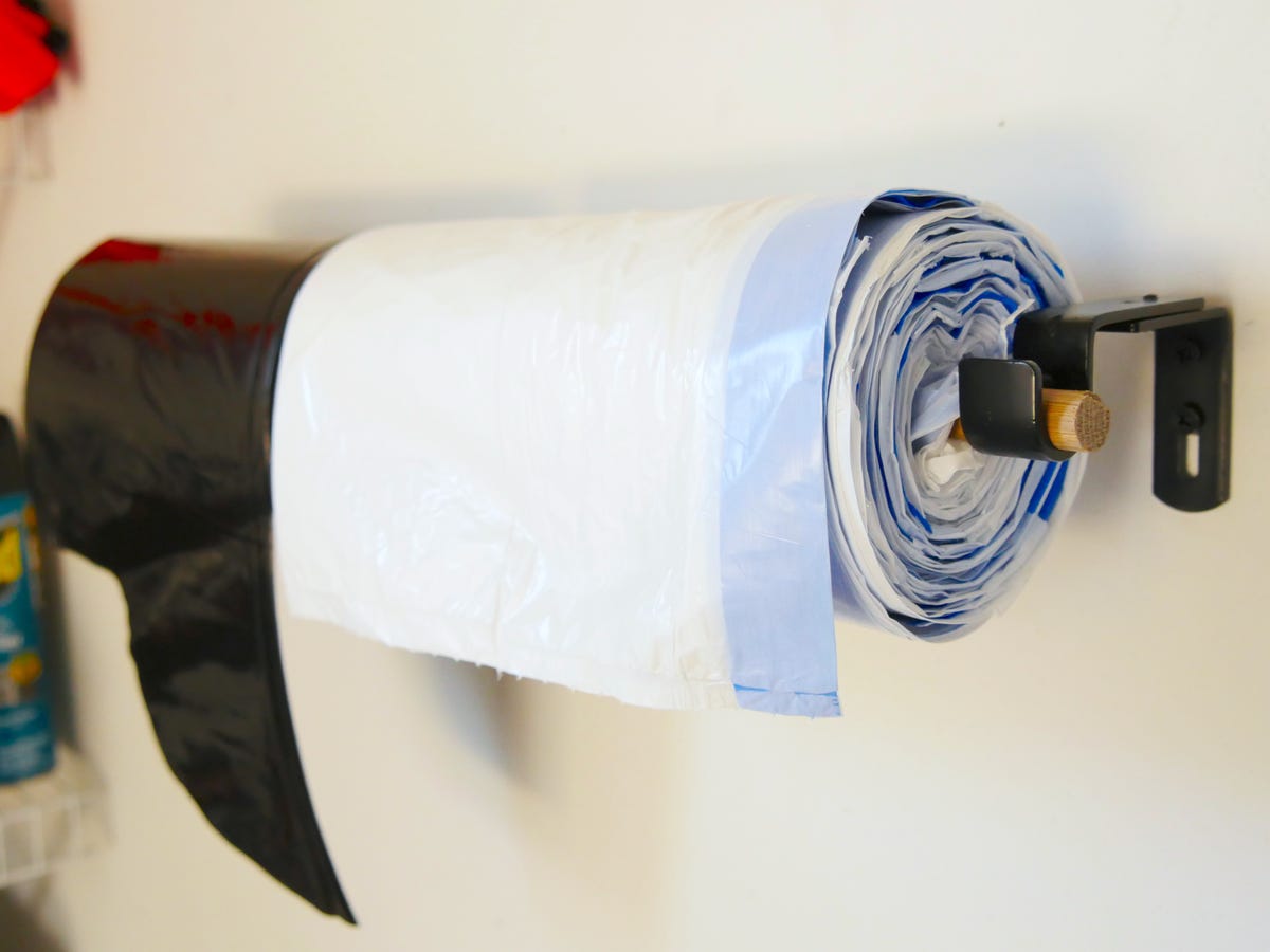 Hang trash bags on a curtain rod in the garage for easier access