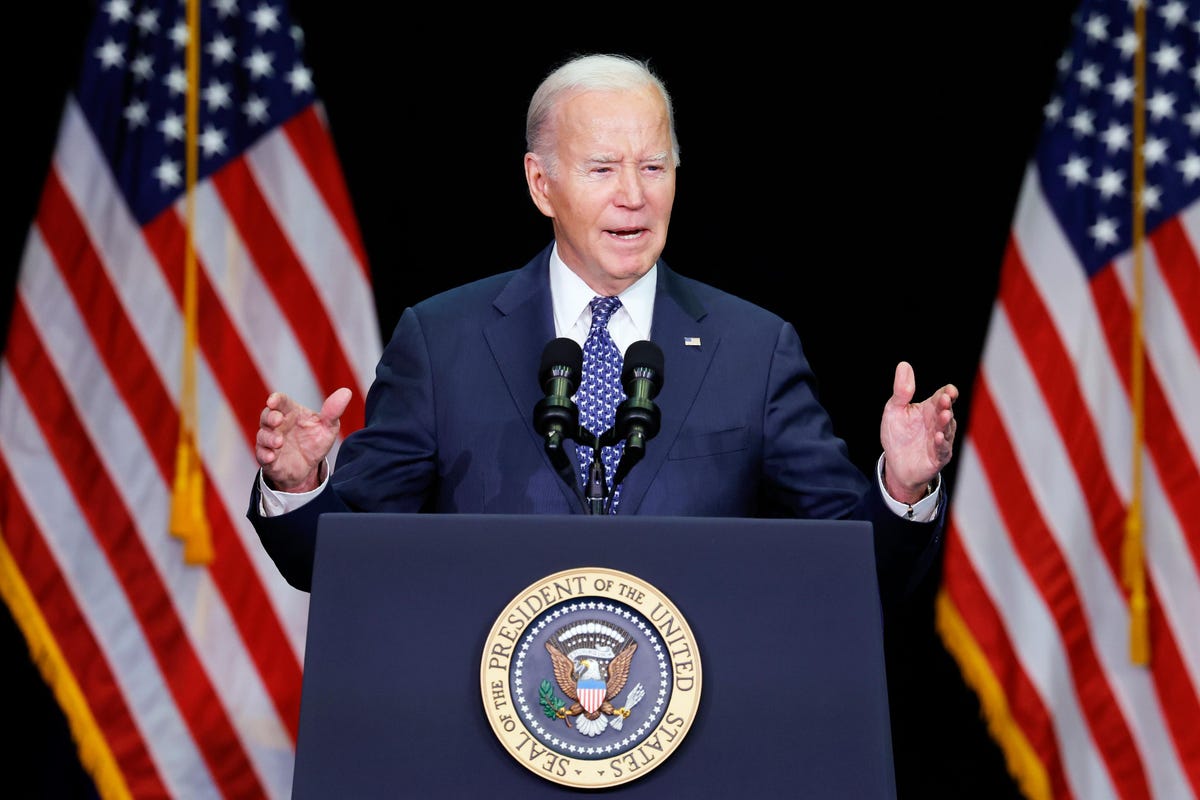 President Joe Biden standing at a podium, gesturing broadly