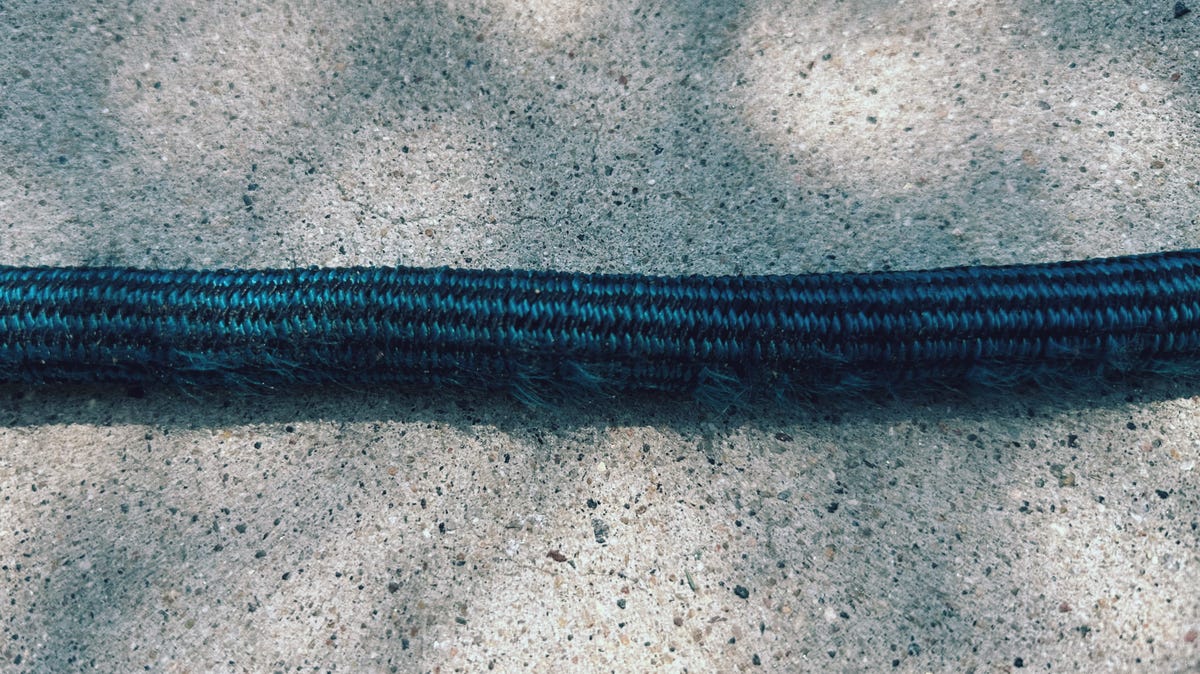 Showing the fraying fabric of the WeGuard expandable garden hose