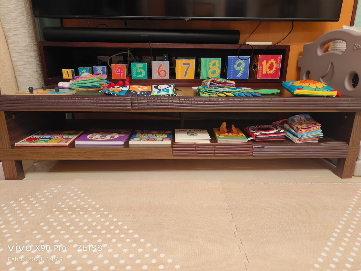 An organized shelf of toys and books