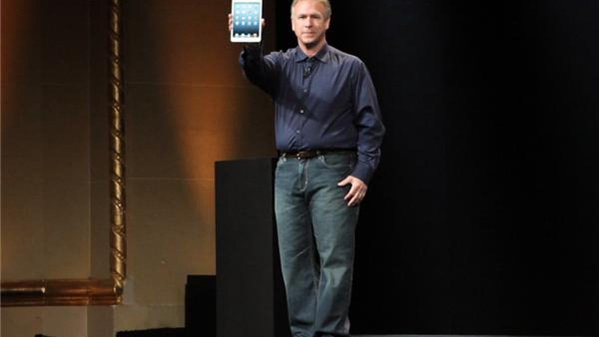 Apple executive Phil Schiller showing off the iPad Mini.
