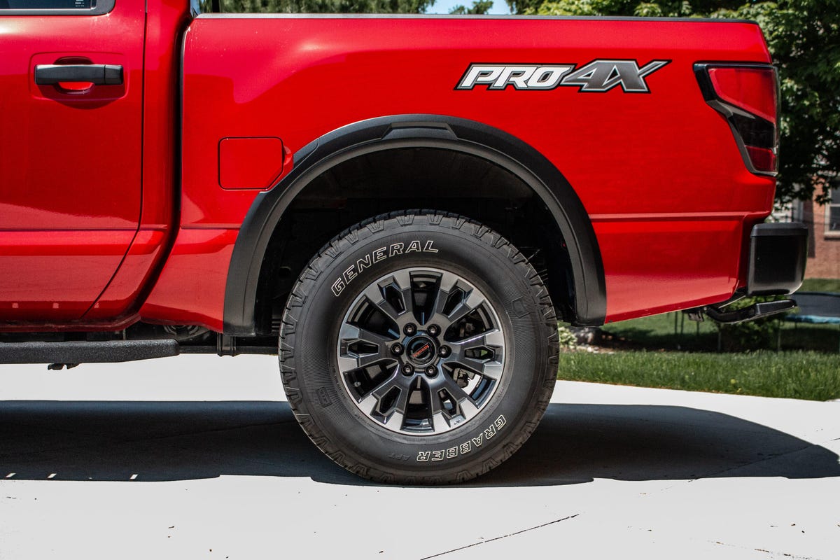 Normal Tires on a Red Nissan Titan Pickup Truck