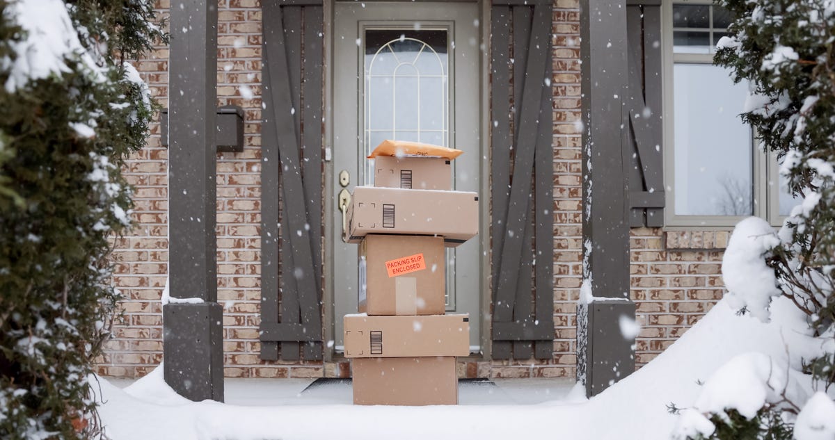 packages sitting on a front porch in the snow