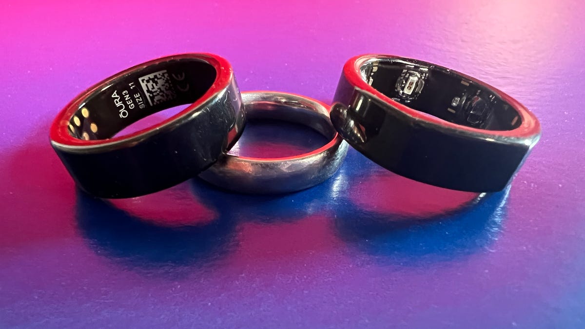 Oura 3 rings next to a wedding ring