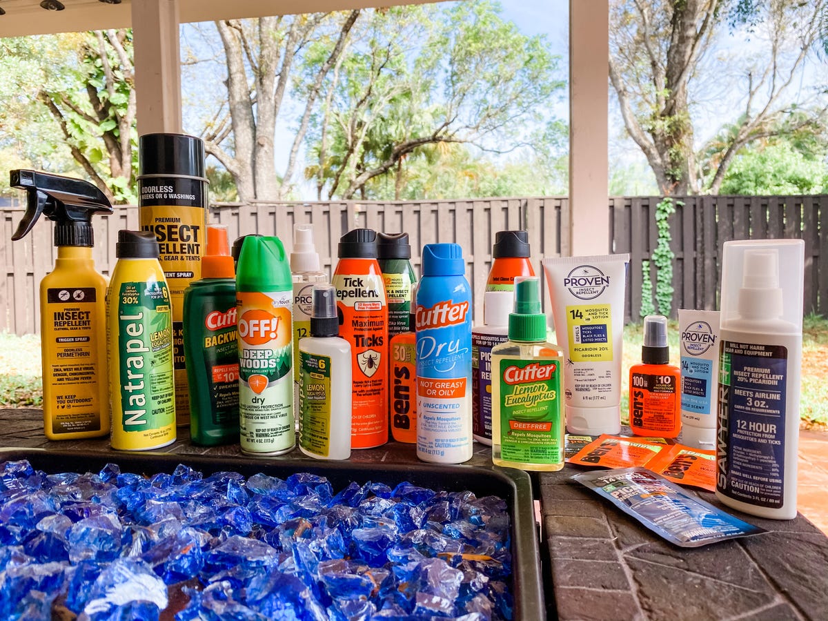 Several types of bug spray lined up on a table