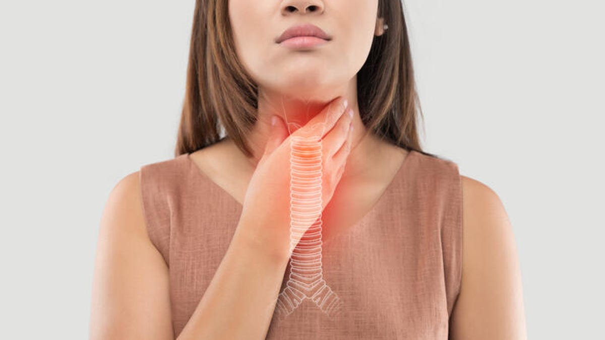 Woman experiencing a burning sensation in the throat.