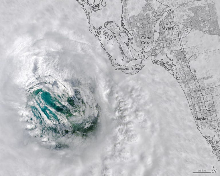 Hurricane Ian looks like a white swirling mass above dark blue ocean with green land masses below and a map of Florida's coast on the right.
