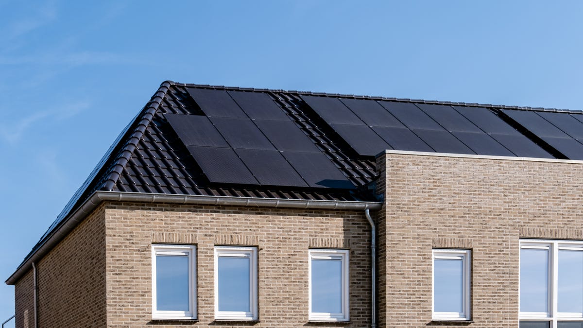 Black solar panels on a roof.