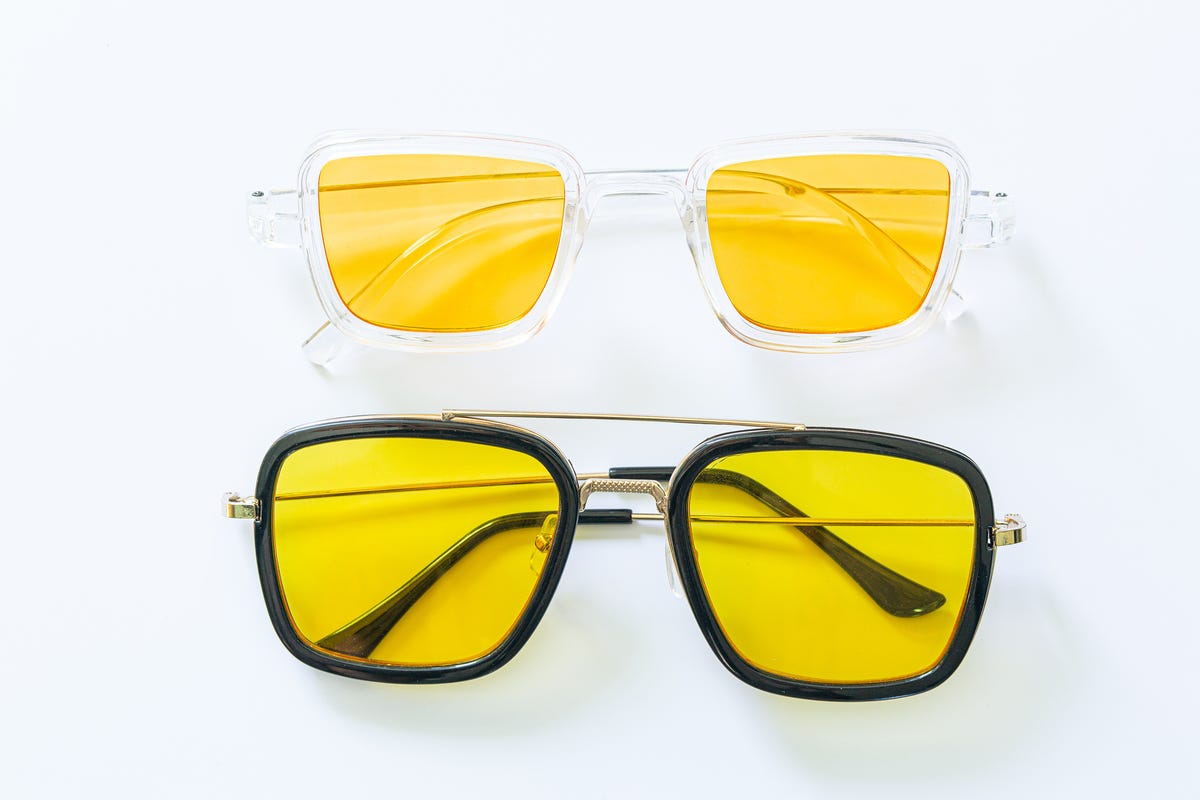 Two pairs of glasses with yellow tinted lenses