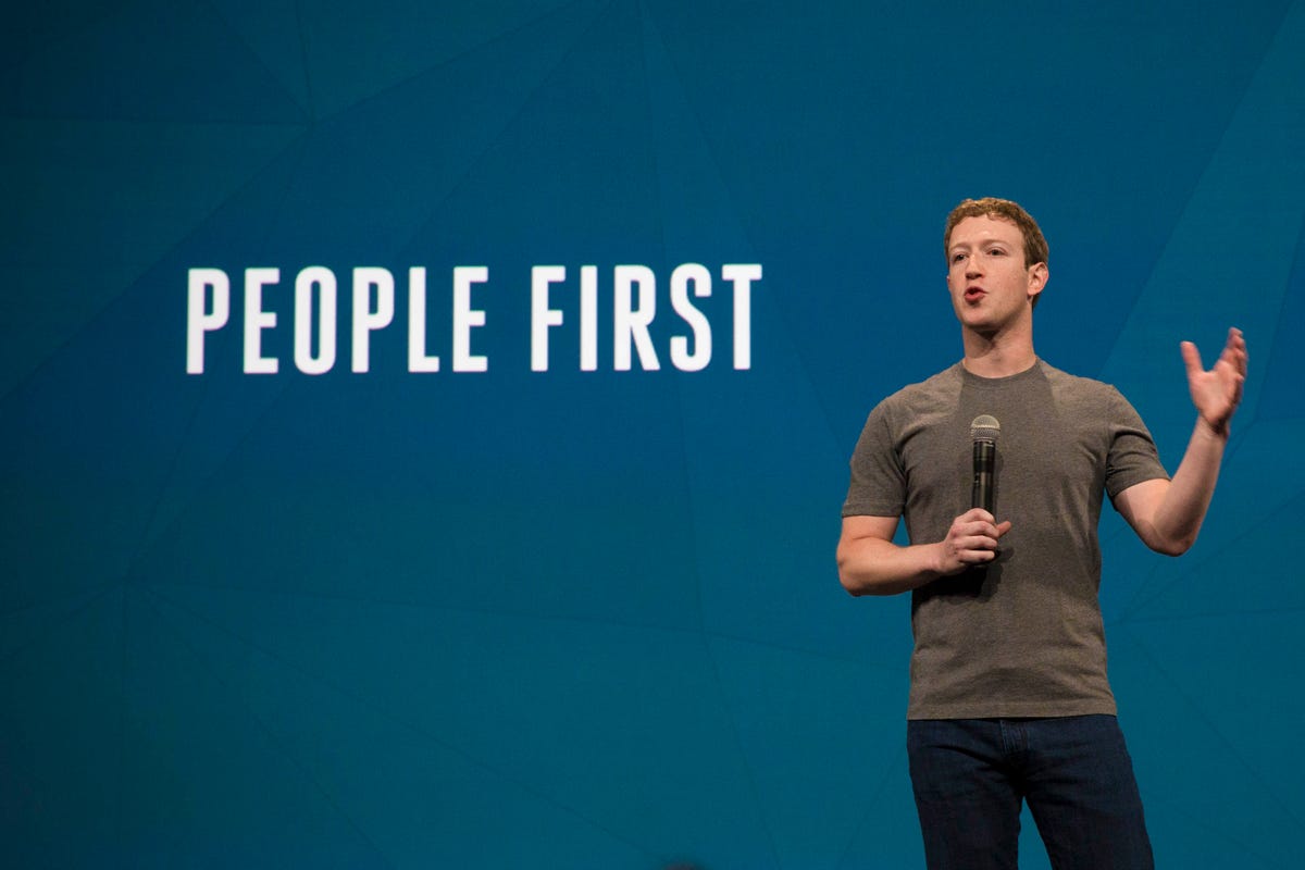 Facebook CEO Mark Zuckerberg in front of a projection reading "People First"