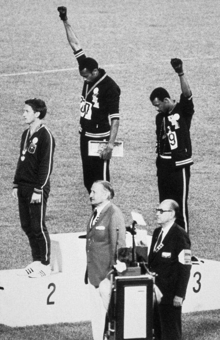 American sprinters Tommie Smith and John Carlos raise their fists as the national anthem plays at the 1968 Olympics.