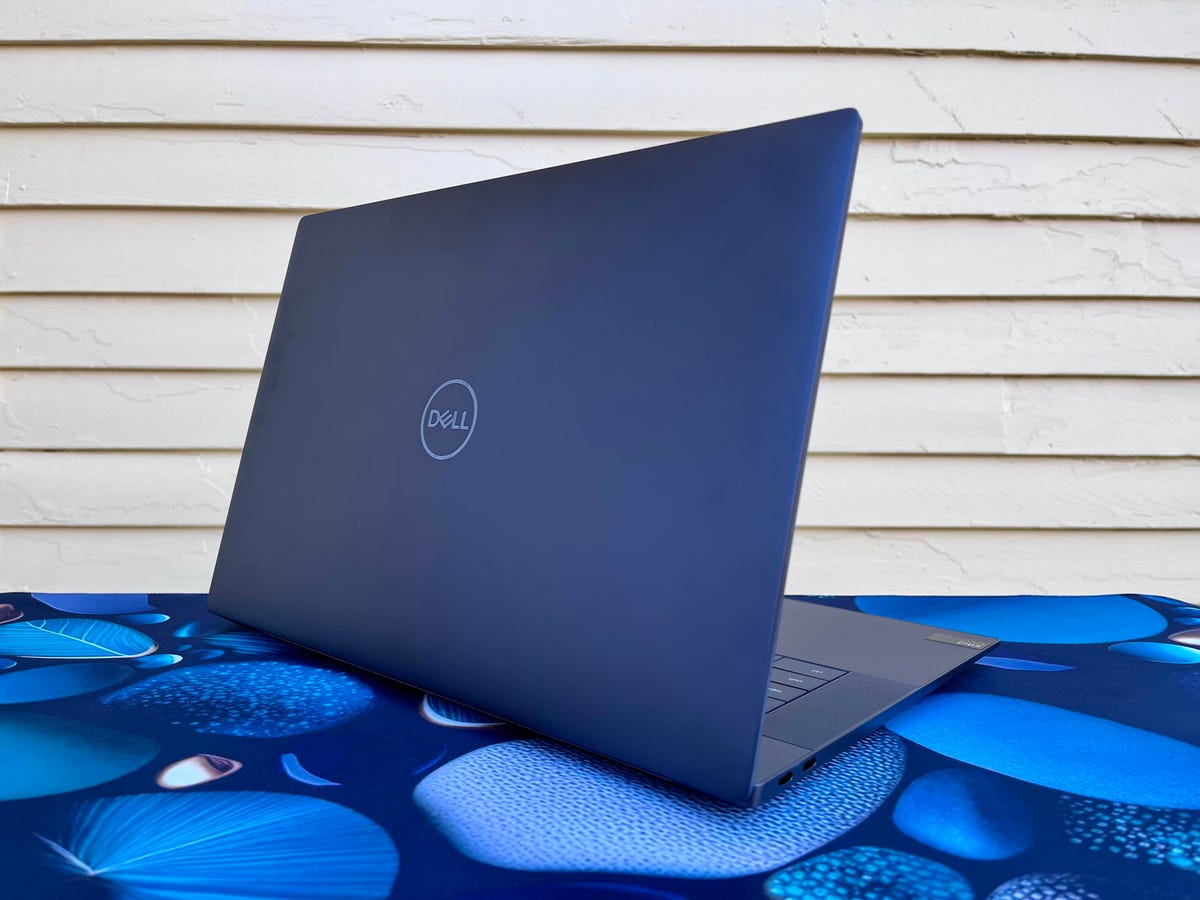 Dell XPS 16 9640 in black in front of a yellow wall