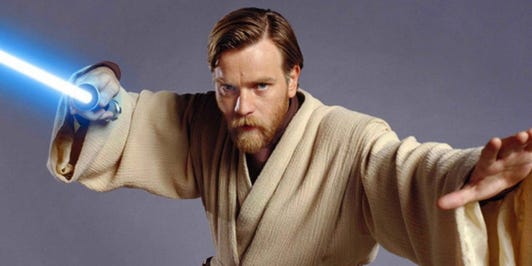 Ewan McGregor wields a lightsaber, beard and intense stare as Obi-Wan Kenobi.