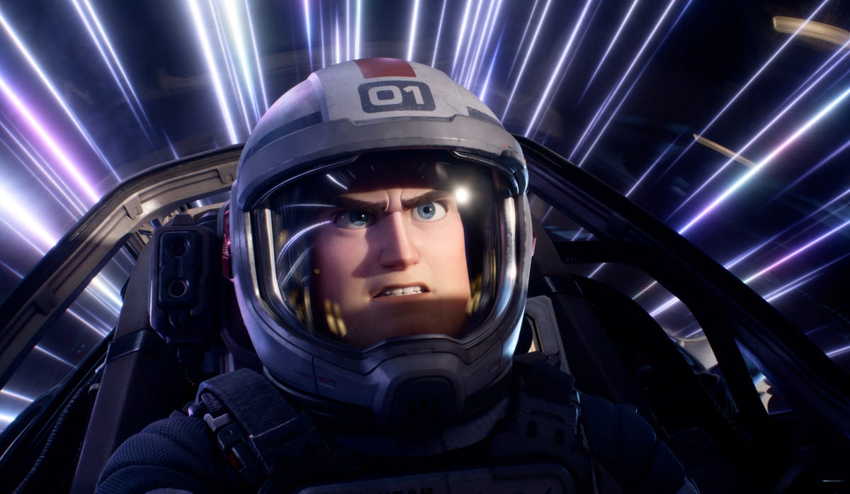 The space ranger who inspired the beloved Buzz Lightyear toy is seen head-on in a cockpit, wearing a pilot's helmet, gritting his teeth and knitting his brow as streaks of light flash by outside.