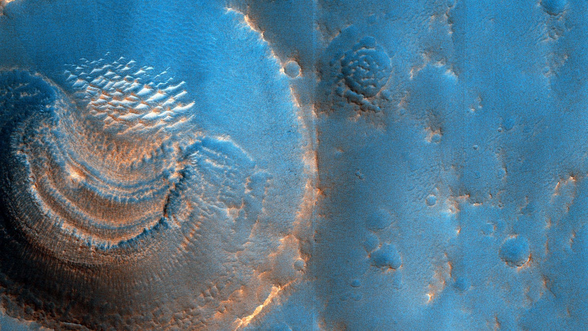 This false-color view of a Mars crater looks blue to highlight a series of layered formations within.