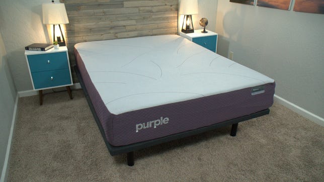 The Purple Restore mattress in a bright room in between two night stands.