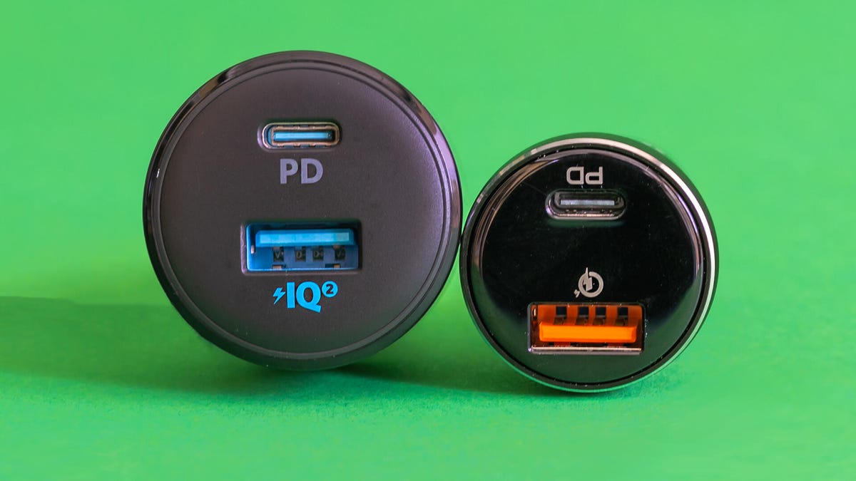 Two car charger adapters side by side on a green background.