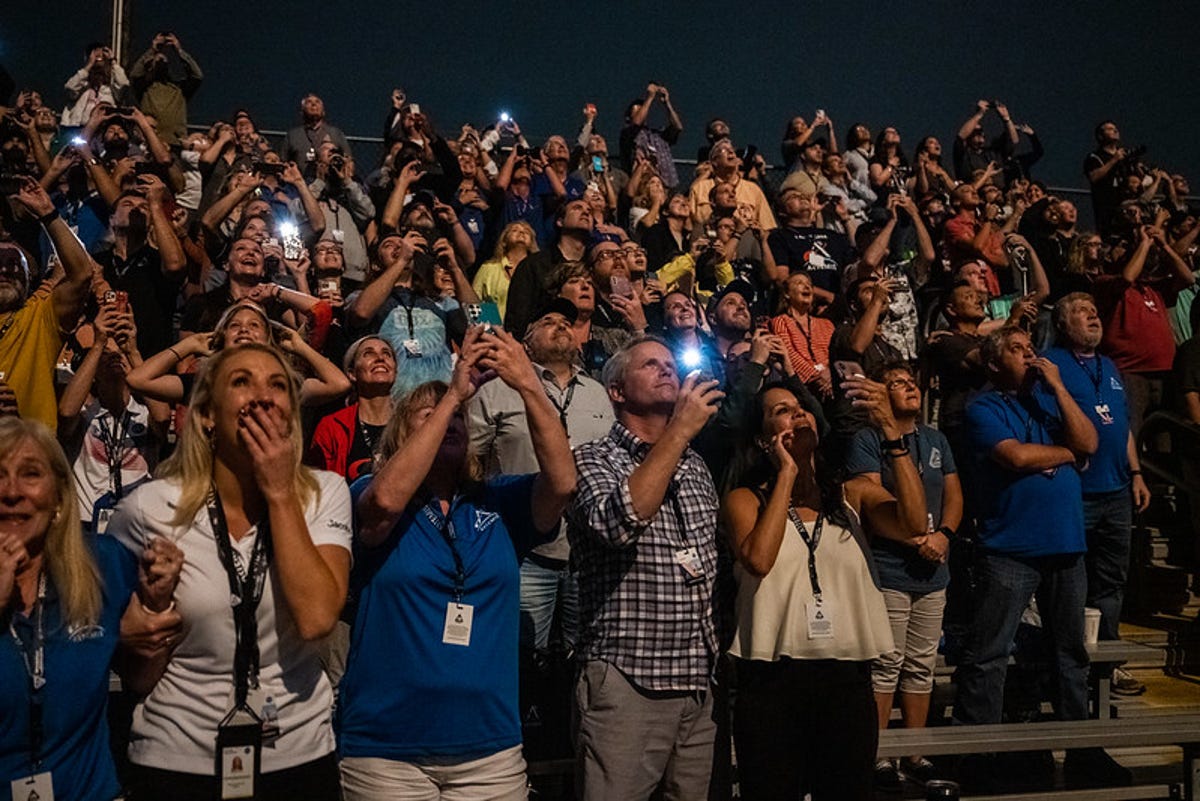 The crowd watching Artemis I's launch is in tears, holding phones to record the show.