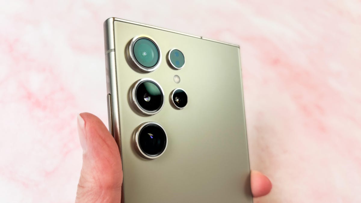 The Samsung Galaxy S24 Ultra&apos;s cameras against a pink marble surface