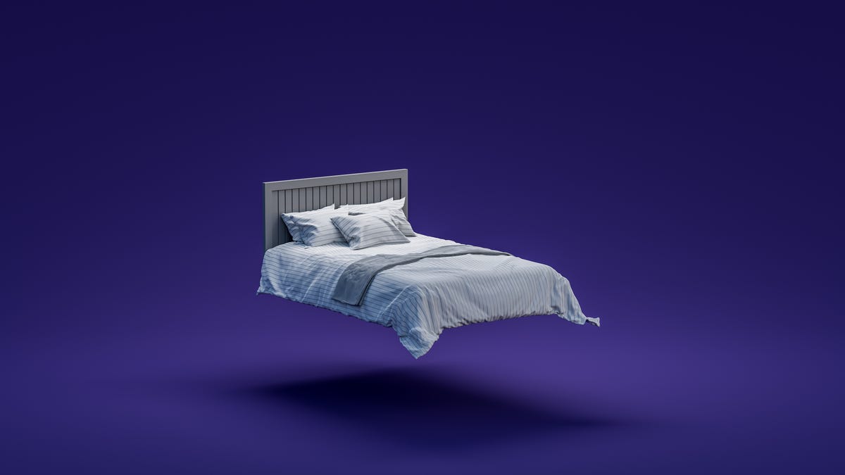 A bed floating against a purple background