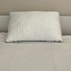 Nest Bedding Easy Breather Pillow on top of a white bed
