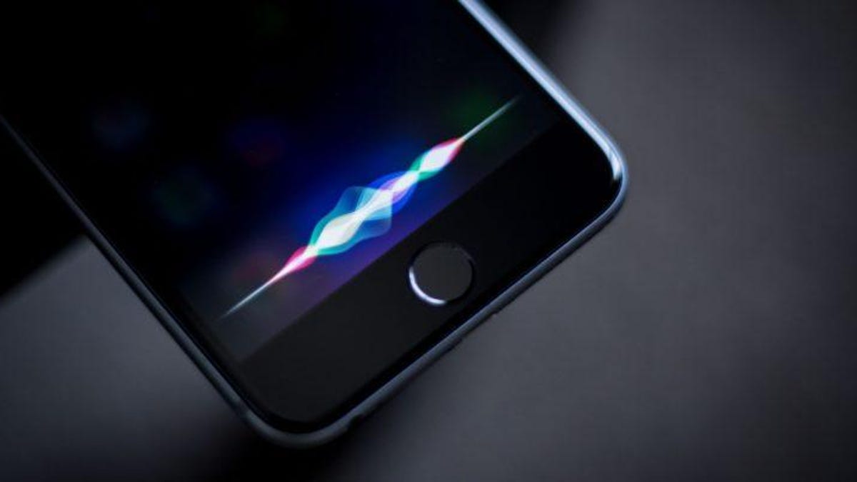 Siri&apos;s "voice" flashing on an iPhone screen.