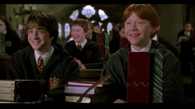 Harry and Ron sit in class in a scene from Harry Potter and the Chamber of Secrets