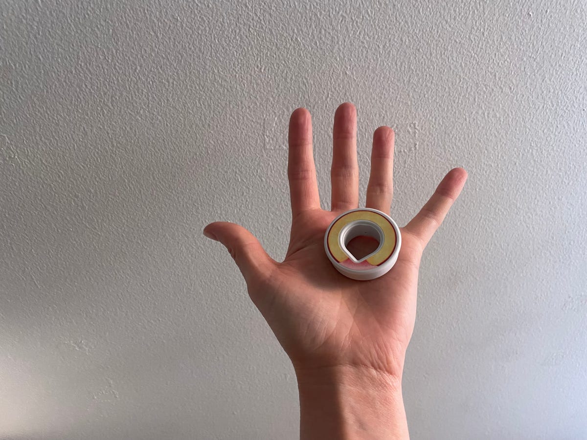 A hand holding an Air Up scented capsule. 