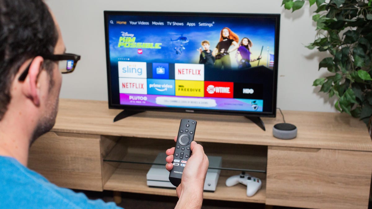 Person using a Fire TV Stick on their Toshiba TV.