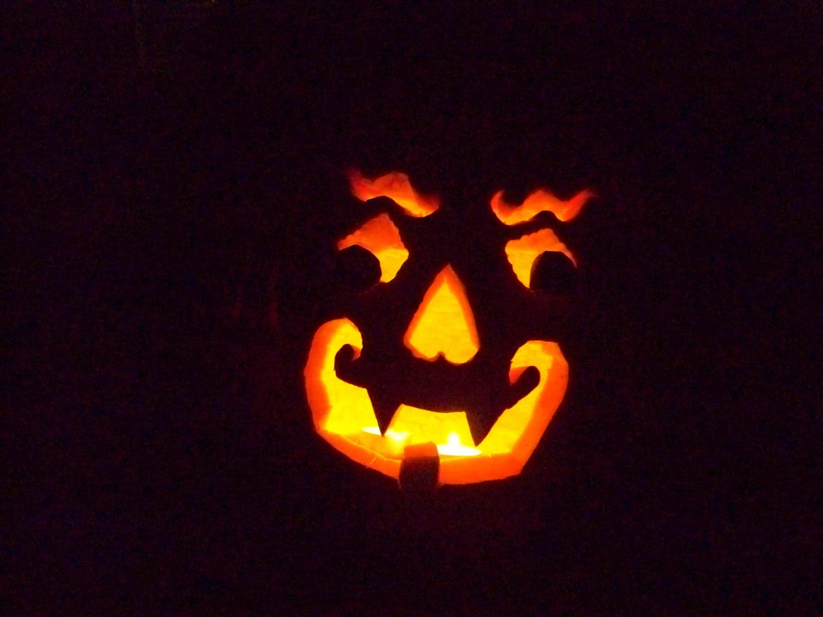 face carved into a pumpkin with black background