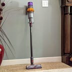 Dyson V15 Detect leaned up against a wall.