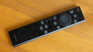 The remote for the Samsung QN90B QLED TV includes mic and streaming service buttons.