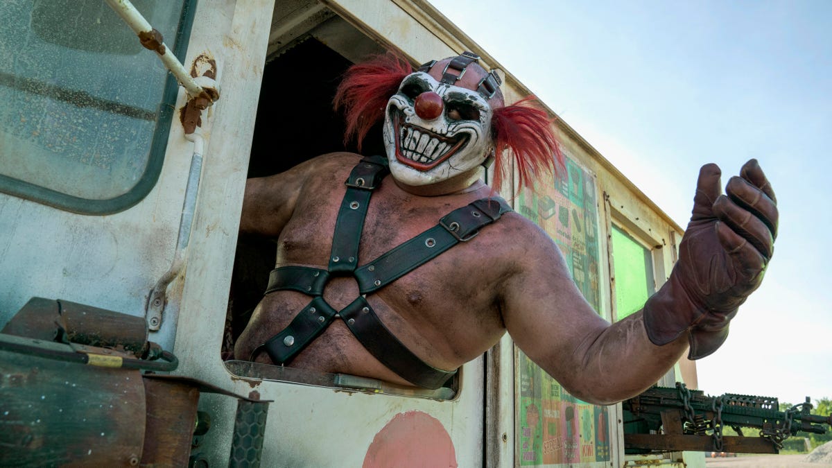 wild dirty clown hangs out of truck window
