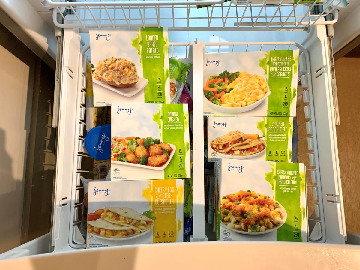 a freezer drawer full of Jenny Craig meal boxes